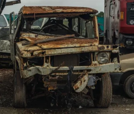 Old vehicle breaking down and leaking battery oil and fluids 
