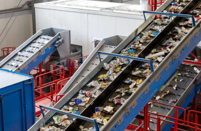 Automated sorting conveyor belt processing plastic waste at a egal vehicle scrapping facility in Goa