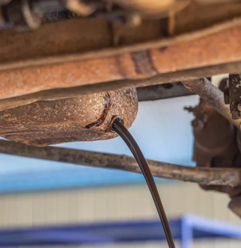 Engine oil being drained before dismantling begins.