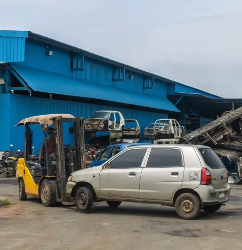 Old car being moved to a scrapyard